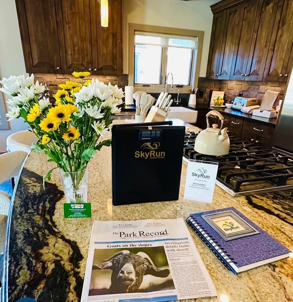 Flowers and welcome gifts arranged on a vacation rental kitchen island